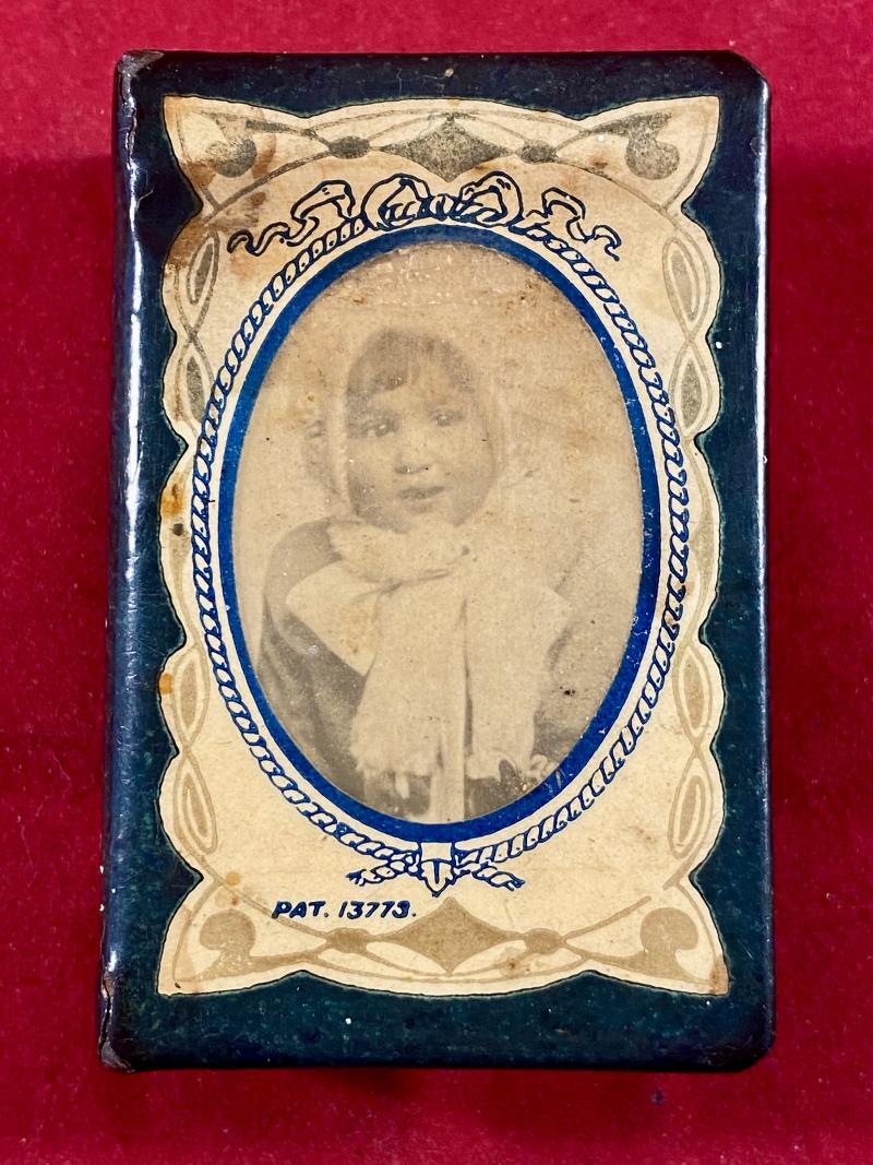 A Sweetheart WW1 Metal and Celluloid Matchbox Cover Depicting a Photo of a Child Wearing a Bonnet