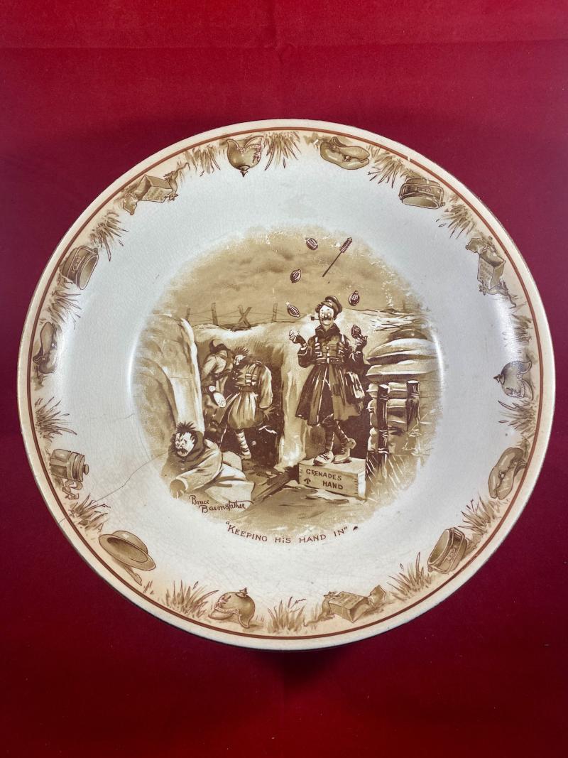 Large WW1 Bruce Bairnsfather 9” Commemorative Dish Depicting a Juggling Grenades Cartoon and the words “KEEPING HIS HAND IN?”