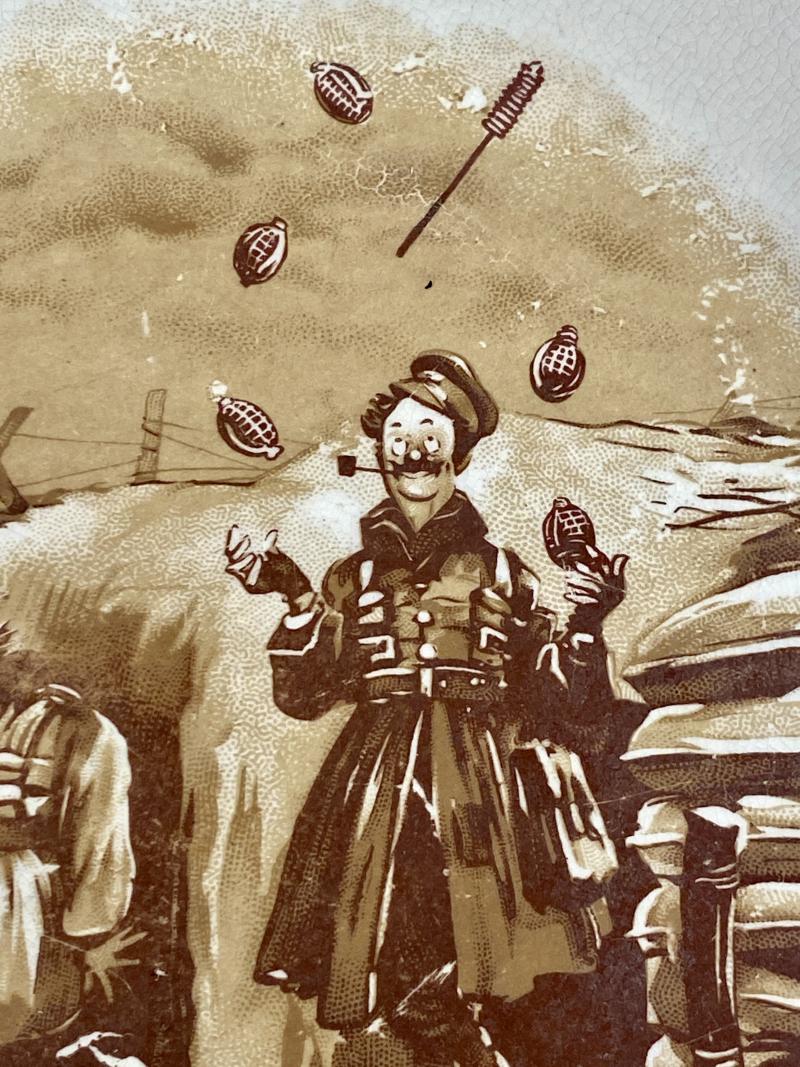 Large WW1 Bruce Bairnsfather 9” Commemorative Dish Depicting a Juggling Grenades Cartoon and the words “KEEPING HIS HAND IN?”