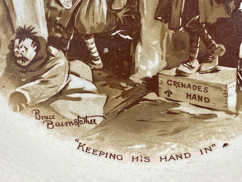 Large WW1 Bruce Bairnsfather 9” Commemorative Dish Depicting a Juggling Grenades Cartoon and the words “KEEPING HIS HAND IN?”