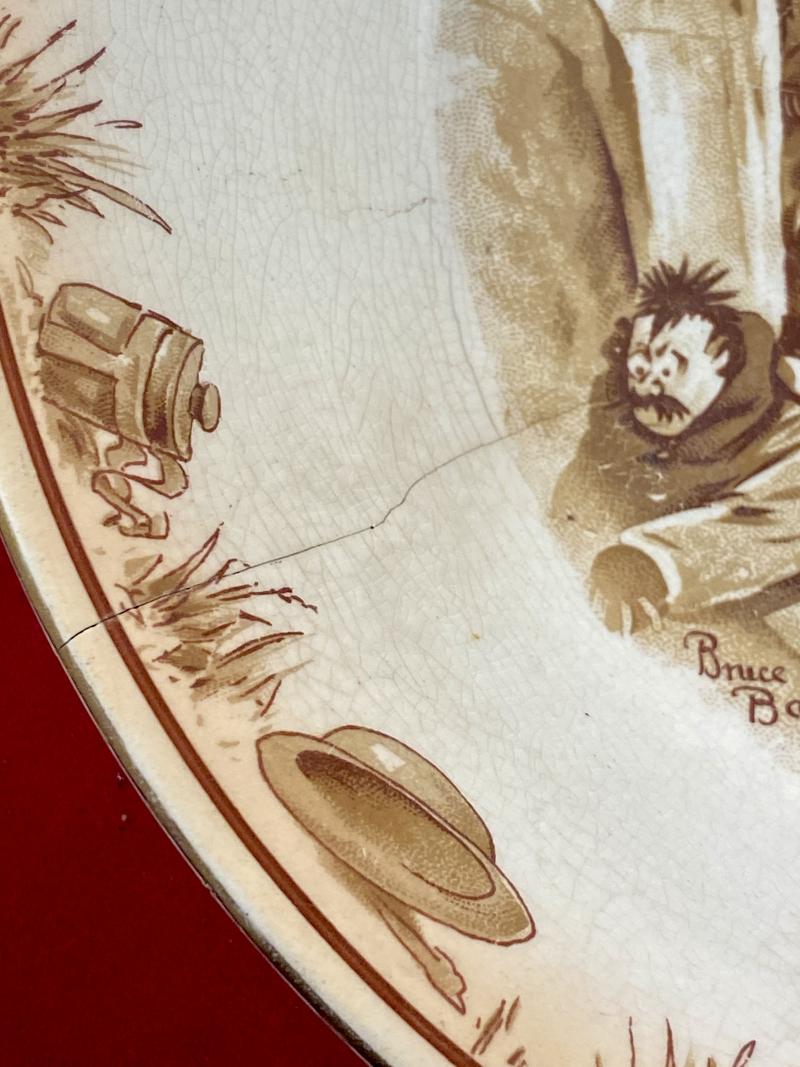 Large WW1 Bruce Bairnsfather 9” Commemorative Dish Depicting a Juggling Grenades Cartoon and the words “KEEPING HIS HAND IN?”