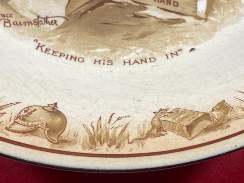 Large WW1 Bruce Bairnsfather 9” Commemorative Dish Depicting a Juggling Grenades Cartoon and the words “KEEPING HIS HAND IN?”